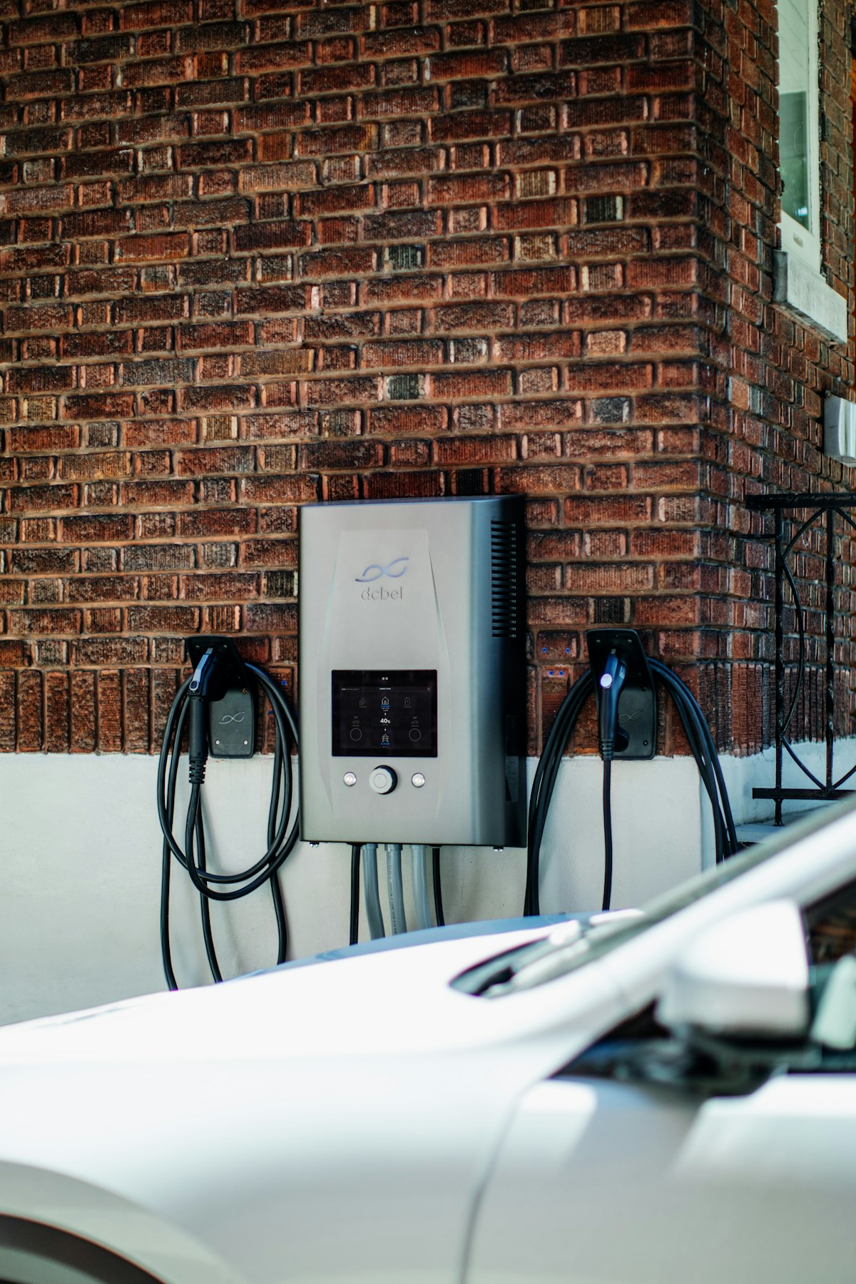 Carregador de veículo elétrico instalado numa parede de tijolo