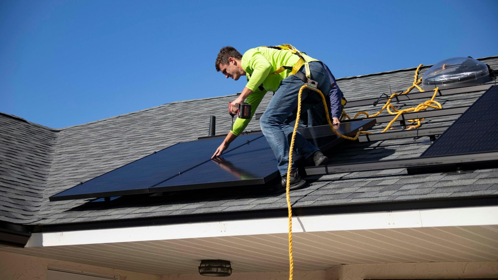 Técnico a instalar painéis solares num telhado
